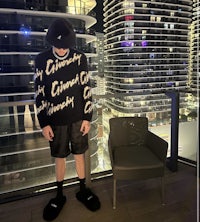 a man standing in front of a building at night